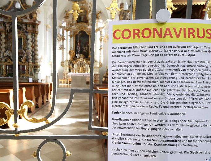 A sign at the entrance of St. Johann Baptist in Aufkirchen near Erding, Germany, explains the temporary ban on public Mass as a precaution against the coronavirus on March 15, 2020. A sign at the entrance of St. Johann Baptist in Aufkirchen near Erding, Germany, explains the temporary ban on public Mass as a precaution against the coronavirus on March 15, 2020.