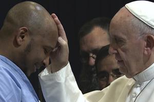 Above, footage of Pope Francis blessing an inmate from Pope Francis: A Man of His Word. Below, director Wim Wenders and Pope Francis. Above, footage of Pope Francis blessing an inmate from Pope Francis: A Man of His Word. Below, director Wim Wenders and Pope Francis.