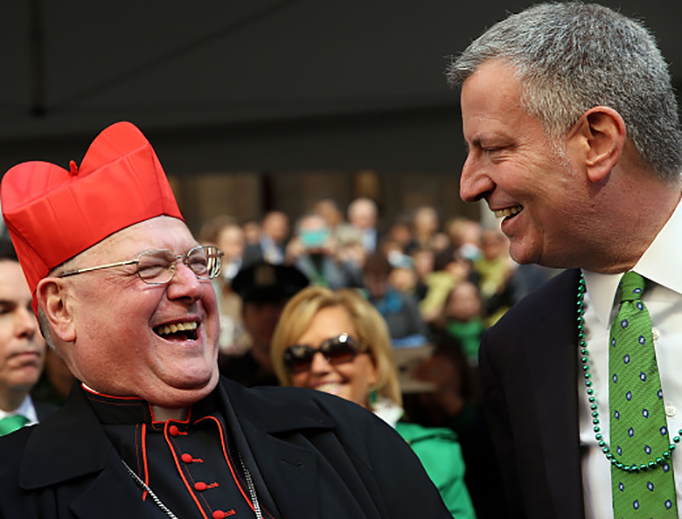 New York Mayor Bill de Blasio pauses with Cardinal Timothy Dolan as he marches in the annual St. Patrick's Day parade on March 17, 2016, in New York City.
New York Mayor Bill de Blasio pauses with Cardinal Timothy Dolan as he marches in the annual St. Patrick's Day parade on March 17, 2016, in New York City.