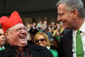 New York Mayor Bill de Blasio pauses with Cardinal Timothy Dolan as he marches in the annual St. Patrick's Day parade on March 17, 2016, in New York City.
New York Mayor Bill de Blasio pauses with Cardinal Timothy Dolan as he marches in the annual St. Patrick's Day parade on March 17, 2016, in New York City.
