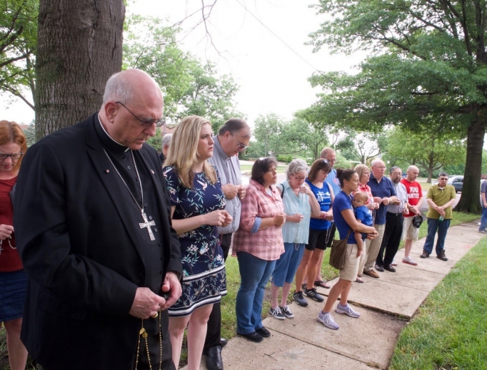 Archbishop Joseph Naumann leads the Rosary in front of Planned Parenthood in Overland Park, Kansas, praying along with archdiocesan pro-life coordinator Allison Donohue (in patterned navy dress) and others. Archbishop Joseph Naumann leads the Rosary in front of Planned Parenthood in Overland Park, Kansas, praying along with archdiocesan pro-life coordinator Allison Donohue (in patterned navy dress) and others.