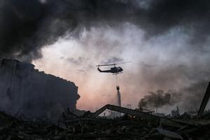 A helicopter puts out a fire at the scene of an explosion at the port of Lebanon's capital Beirut on August 4, 2020. A helicopter puts out a fire at the scene of an explosion at the port of Lebanon's capital Beirut on August 4, 2020.