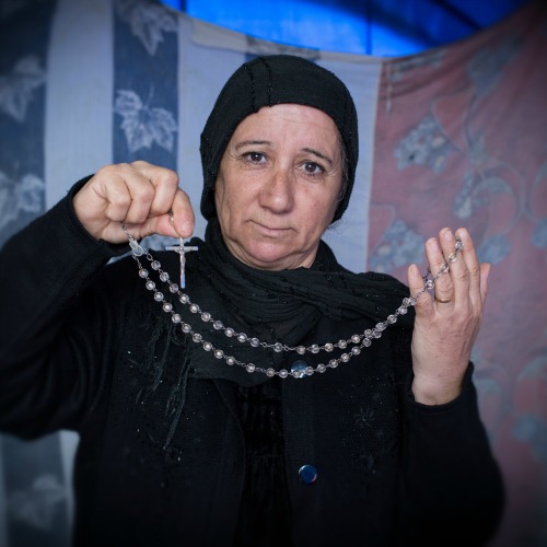 A displaced Iraqi-Christian woman from Qaraqosh displays her most prized possession last month in her tented home located on the grounds of Mar Elia Catholic Church in Erbil, Iraq. A displaced Iraqi-Christian woman from Qaraqosh displays her most prized possession last month in her tented home located on the grounds of Mar Elia Catholic Church in Erbil, Iraq.