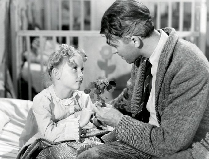 Actress Karolyn Grimes, as ZuZu Bailey, with Jimmy Stewart, as George Bailey, in It’s a Wonderful Life. Actress Karolyn Grimes, as ZuZu Bailey, with Jimmy Stewart, as George Bailey, in It’s a Wonderful Life.