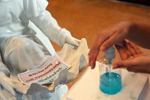 A person applies hand sanitizer gel in front of an empty font with a sign saying, “no holy water during COVID-19 precautionary period” before Sunday Mass at Holy Redeemer Catholic Church in Bangkok on March 8. A person applies hand sanitizer gel in front of an empty font with a sign saying, “no holy water during COVID-19 precautionary period” before Sunday Mass at Holy Redeemer Catholic Church in Bangkok on March 8.