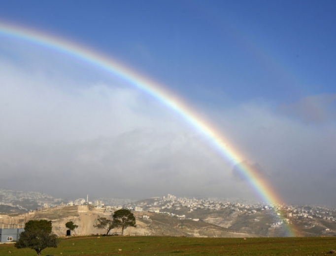 A picture taken Jan. 31 shows a rainbow over the Palestinian village of Abu Dis in the West Bank. U.S. President Donald Trump unveiled his plan for the Middle East Jan. 28, recognizing disputed Jerusalem as Israel’s ‘undivided’ capital but acknowledging the Palestinians’ desire for a capital in ‘eastern Jerusalem’ and said it could be established
in Abu Dis, a Palestinian village adjacent to Jerusalem that is physically separated by an Israeli barrier.
A picture taken Jan. 31 shows a rainbow over the Palestinian village of Abu Dis in the West Bank. U.S. President Donald Trump unveiled his plan for the Middle East Jan. 28, recognizing disputed Jerusalem as Israel’s ‘undivided’ capital but acknowledging the Palestinians’ desire for a capital in ‘eastern Jerusalem’ and said it could be established
in Abu Dis, a Palestinian village adjacent to Jerusalem that is physically separated by an Israeli barrier.