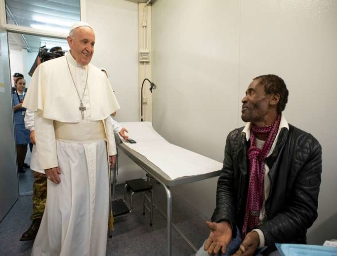Pope Francis visits with a patient inside a clinic for the poor in Rome, 2019. Pope Francis visits with a patient inside a clinic for the poor in Rome, 2019.