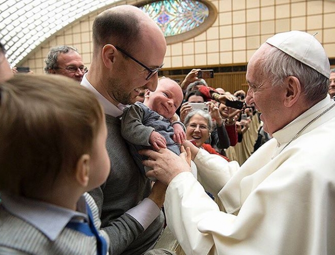 Pope Francis greets a family at the Vatican. Pope Francis greets a family at the Vatican.