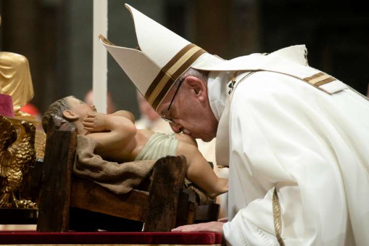 Pope Francis kisses an image of the Christ Child at Christmas Mass in St. Peter's Basilica Dec. 24, 2018. Pope Francis kisses an image of the Christ Child at Christmas Mass in St. Peter's Basilica Dec. 24, 2018.