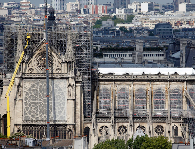Temporary tarpaulins cover the roof of the Notre-Dame cathedral to protect it from the rain damage following the massive fire earlier this month, on April 29, 2019 in Paris, France. More than 1,000 conservators, architects and professors from France and abroad have spoken out against President Macron's promise to rebuild Notre Dame within five years, citing fears that a hasty restoration would be irresponsible. Temporary tarpaulins cover the roof of the Notre-Dame cathedral to protect it from the rain damage following the massive fire earlier this month, on April 29, 2019 in Paris, France. More than 1,000 conservators, architects and professors from France and abroad have spoken out against President Macron's promise to rebuild Notre Dame within five years, citing fears that a hasty restoration would be irresponsible.