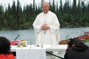 Above, Father Kermit Syren, founder of Camp Kodiak, celebrates Mass last summer on the banks of Alaska’s Gulkana River. Daily Mass is part of the morning tradition at ‘Camp Kodiak’ high-adventure camp. Below, Camp Kodiak participants pray during an outdoor Stations of the Cross at the entrance of the Wrangell St. Elias National Park in Alaska. Above, Father Kermit Syren, founder of Camp Kodiak, celebrates Mass last summer on the banks of Alaska’s Gulkana River. Daily Mass is part of the morning tradition at ‘Camp Kodiak’ high-adventure camp. Below, Camp Kodiak participants pray during an outdoor Stations of the Cross at the entrance of the Wrangell St. Elias National Park in Alaska.