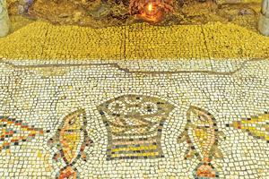 The mosaic floor of the Multiplication Church in Tabgha, Israel, depicts the fishes and basket with loaves with which Jesus fed 5,000 people. The mosaic floor of the Multiplication Church in Tabgha, Israel, depicts the fishes and basket with loaves with which Jesus fed 5,000 people.