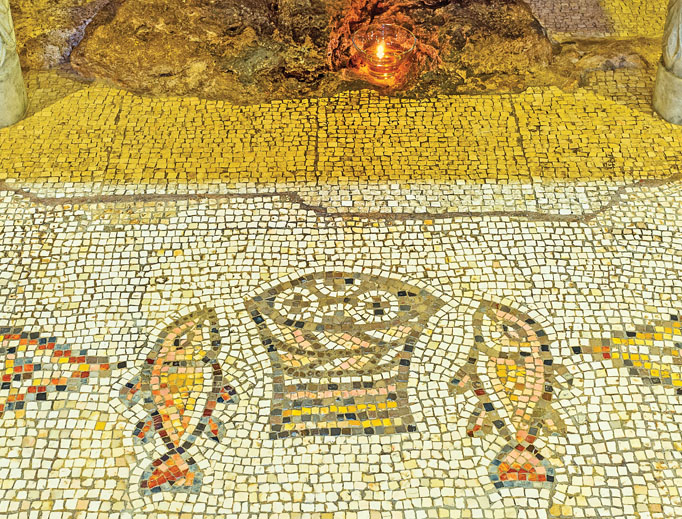 The mosaic floor of the Multiplication Church in Tabgha, Israel, depicts the fishes and basket with loaves with which Jesus fed 5,000 people. The mosaic floor of the Multiplication Church in Tabgha, Israel, depicts the fishes and basket with loaves with which Jesus fed 5,000 people.