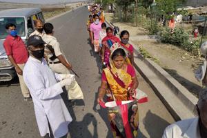 A long line of residents line up for food and relief distribution offered by St Xavier's College of Management and Technology, Patna. A long line of residents line up for food and relief distribution offered by St Xavier's College of Management and Technology, Patna.