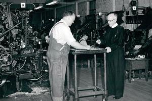 National Catholic Register founding editor Msgr. Matthew Smith (R) reviews an issue in the Register’s mid-century print facility. National Catholic Register founding editor Msgr. Matthew Smith (R) reviews an issue in the Register’s mid-century print facility.