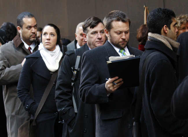People wait in line for a job fair in New York's Times Square. People wait in line for a job fair in New York's Times Square.