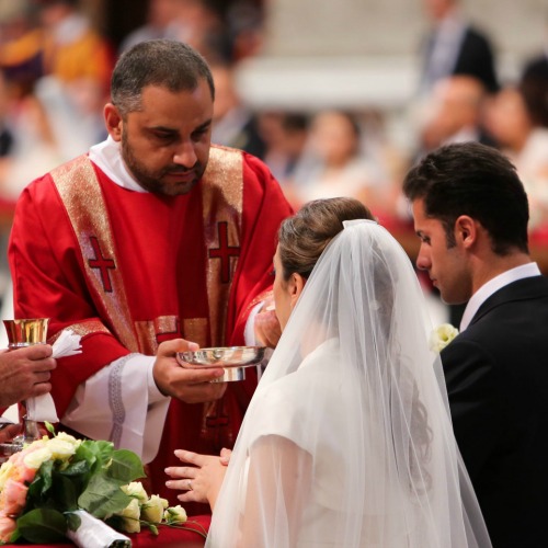 A couple newly married by Pope Francis receives Communion in St. Peter's Basilica on Sept. 14. A couple newly married by Pope Francis receives Communion in St. Peter's Basilica on Sept. 14.