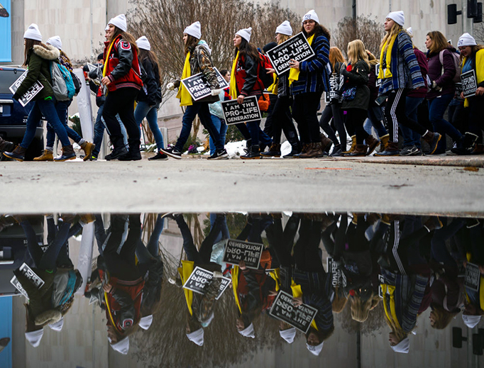 Marchers carry signs during the annual "March for Life" in Washington, D.C., Jan. 18, 2019. Marchers carry signs during the annual "March for Life" in Washington, D.C., Jan. 18, 2019.