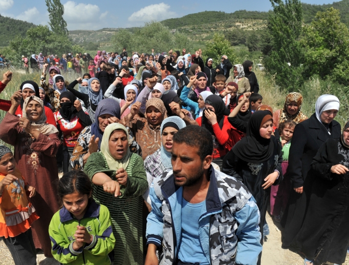 Syrian refugees gather on the Syria/Turkey border. Syrian refugees gather on the Syria/Turkey border.