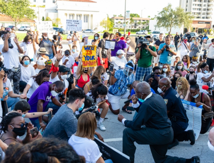 Protesters kneel in prayer in Coral Gables, Florida on May 30, 2020. Protesters kneel in prayer in Coral Gables, Florida on May 30, 2020.