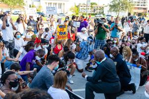 Protesters kneel in prayer in Coral Gables, Florida on May 30, 2020. Protesters kneel in prayer in Coral Gables, Florida on May 30, 2020.