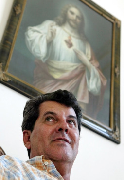 Oswaldo Payá, Cuba's leading dissident and who started the Varela Project, sits underneath a painting of the Sacred Heart in Havana. Oswaldo Payá, Cuba's leading dissident and who started the Varela Project, sits underneath a painting of the Sacred Heart in Havana.
