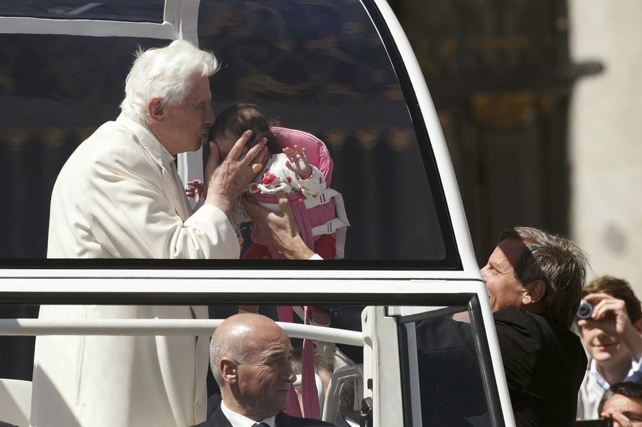 Pope Benedict XVI kisses a baby as he leaves his general audience in St. Peter's Square at the Vatican April 13. Pope Benedict XVI kisses a baby as he leaves his general audience in St. Peter's Square at the Vatican April 13.