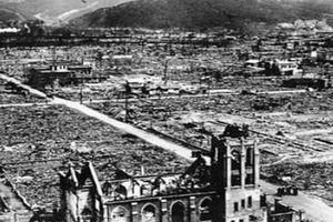 An aerial view of Our Lady of the Assumption Church after the Aug. 6, 1945, bombing. A small group of priests can be seen standing in the road in front of the church. An aerial view of Our Lady of the Assumption Church after the Aug. 6, 1945, bombing. A small group of priests can be seen standing in the road in front of the church.