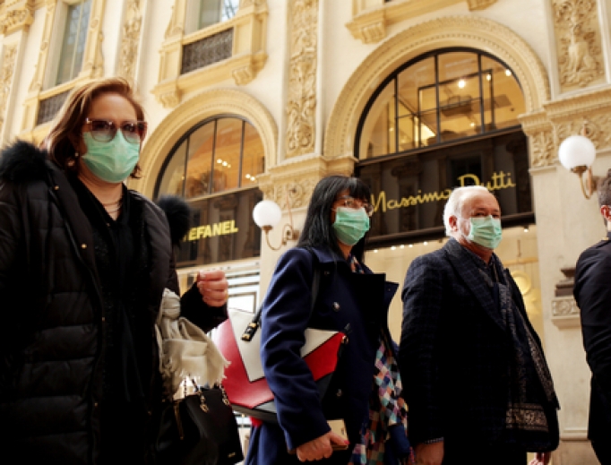 As coronavirus hits Italy, tourists wear protective masks at the Wiktor Emanuel II Gallery in Milan Feb. 22. As coronavirus hits Italy, tourists wear protective masks at the Wiktor Emanuel II Gallery in Milan Feb. 22.