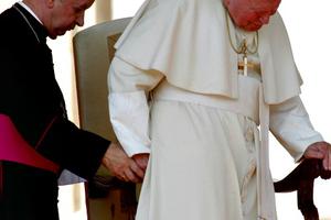 Then-Archbishop Stanislaw Dziwisz helps Pope John Paul II to his chair as the Holy Father arrives for his weekly general audience on Oct. 2, 2002. Then-Archbishop Stanislaw Dziwisz helps Pope John Paul II to his chair as the Holy Father arrives for his weekly general audience on Oct. 2, 2002.