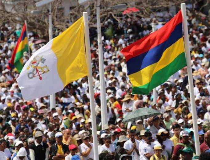 People wave flags during Mass with Pope Francis in Port Louis, Mauritius, Sept. 9. People wave flags during Mass with Pope Francis in Port Louis, Mauritius, Sept. 9.