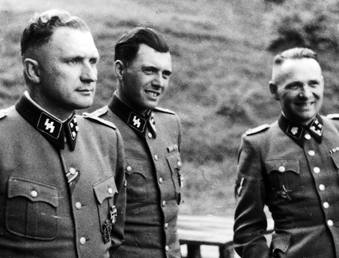Three SS officers socialize at Auschwitz in 1944. From left to right: Richard Baer (commandant), Dr. Josef Mengele and Rudolf Höss (former commandant). Baer escaped but was captured in 1960; he died in 1963 while awaiting trial. Höss was executed for his crimes in 1947, shortly after receiving the sacrament of penance and Holy Communion as Viaticum. Mengele died while swimming at a seaside resort in 1979, after having lived to see his work at Auschwitz vindicated by the legalization of abortion in the U.S. and elsewhere. Three SS officers socialize at Auschwitz in 1944. From left to right: Richard Baer (commandant), Dr. Josef Mengele and Rudolf Höss (former commandant). Baer escaped but was captured in 1960; he died in 1963 while awaiting trial. Höss was executed for his crimes in 1947, shortly after receiving the sacrament of penance and Holy Communion as Viaticum. Mengele died while swimming at a seaside resort in 1979, after having lived to see his work at Auschwitz vindicated by the legalization of abortion in the U.S. and elsewhere.