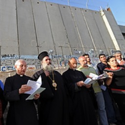 Christian leaders pray in front of the Israeli separation wall near Rachel's Tomb in Bethlehem, West Bank. Christian leaders pray in front of the Israeli separation wall near Rachel's Tomb in Bethlehem, West Bank.
