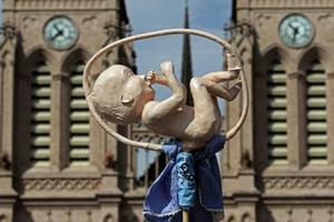 A model of a fetus is seen in front of the Basilica of the Virgin of Lujan, as the Argentine Catholic Church celebrates a March 8 Mass to pray for the rejection of the bill proposed by President Alberto Fernandez to decriminalizes abortion. A model of a fetus is seen in front of the Basilica of the Virgin of Lujan, as the Argentine Catholic Church celebrates a March 8 Mass to pray for the rejection of the bill proposed by President Alberto Fernandez to decriminalizes abortion.