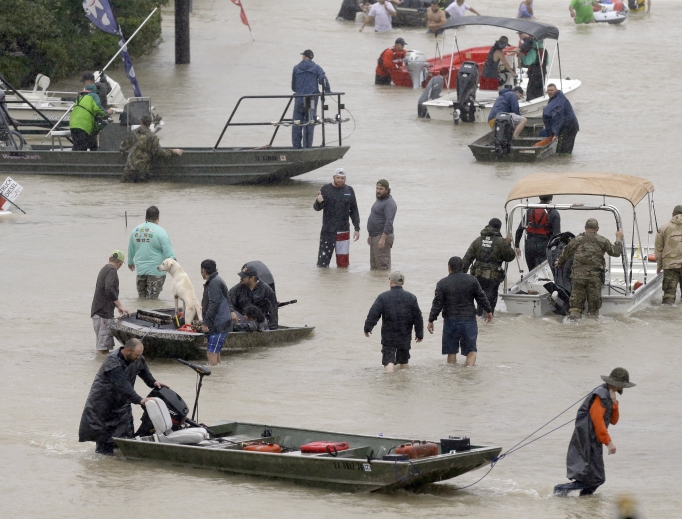 Above, people and rescue boats line a street at the east Sam Houston Tollway as evacuations continue from flooding in Houston Aug. 28. Below, a rescuer moves Paulina Tamirano, 92, from a boat to a truck bed as people evacuate from the Savannah Estates neighborhood as Addicks Reservoir nears capacity Aug. 29 in Houston. Houston Police SWAT officer Daryl Hudeck carries Catherine Pham and her 13-month-old son, Aiden, after rescuing them from their home surrounded by floodwaters Aug. 27 in Houston. An image of Our Lady of Guadalupe sits on Hickory Lane in Crosby, Texas, Sept. 1. Staff Sgt. Lawrence Lind, left, hoists a child into a Black Hawk helicopter while Sgt. Ray Smith, right, helps the boy who was rescued in Port Arthur, Texas, Aug. 30. Above, people and rescue boats line a street at the east Sam Houston Tollway as evacuations continue from flooding in Houston Aug. 28. Below, a rescuer moves Paulina Tamirano, 92, from a boat to a truck bed as people evacuate from the Savannah Estates neighborhood as Addicks Reservoir nears capacity Aug. 29 in Houston. Houston Police SWAT officer Daryl Hudeck carries Catherine Pham and her 13-month-old son, Aiden, after rescuing them from their home surrounded by floodwaters Aug. 27 in Houston. An image of Our Lady of Guadalupe sits on Hickory Lane in Crosby, Texas, Sept. 1. Staff Sgt. Lawrence Lind, left, hoists a child into a Black Hawk helicopter while Sgt. Ray Smith, right, helps the boy who was rescued in Port Arthur, Texas, Aug. 30.
