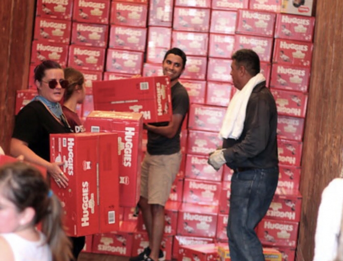 Volunteers of New Wave Feminists unload diapers and supplies in McAllen, Texas, 2019. Volunteers of New Wave Feminists unload diapers and supplies in McAllen, Texas, 2019.