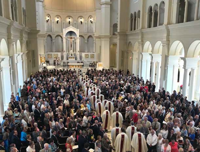 Priests process in for the July 26 Mass of dedication at Holy Name of Jesus Cathedral in Raleigh, North Carolina. Priests process in for the July 26 Mass of dedication at Holy Name of Jesus Cathedral in Raleigh, North Carolina.