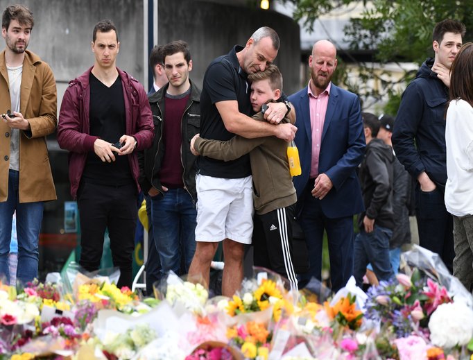 Members of the public mourn before a makeshift memorial near London Bridge June 5. Members of the public mourn before a makeshift memorial near London Bridge June 5.