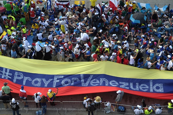 Pilgrims hold a giant flag reading 'Pray for Venezuela' as they wait Jan. 24 for the arrival of Pope Francis for his welcoming ceremony at Campo Santa Maria La Antigua in Panama City during World Youth Day. Pilgrims hold a giant flag reading 'Pray for Venezuela' as they wait Jan. 24 for the arrival of Pope Francis for his welcoming ceremony at Campo Santa Maria La Antigua in Panama City during World Youth Day.