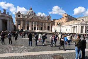Pilgrims in St. Peter's Square watch the video broadcast of the Angelus March 8. Pilgrims in St. Peter's Square watch the video broadcast of the Angelus March 8.