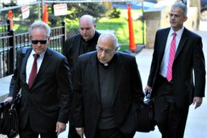 In this April 14 photo, lawyers lead Franciscans Franciscan Fathers Giles Schinelli (front) and Anthony Criscitelli to their hearing at the Blair County courthouse in Hollidaysburg, Pa. The men are charged with allowing a suspected sexual predator to teach at a Pennsylvania high school and hold other jobs where he molested more than 100 children. In this April 14 photo, lawyers lead Franciscans Franciscan Fathers Giles Schinelli (front) and Anthony Criscitelli to their hearing at the Blair County courthouse in Hollidaysburg, Pa. The men are charged with allowing a suspected sexual predator to teach at a Pennsylvania high school and hold other jobs where he molested more than 100 children.