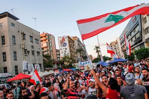 Lebanese anti-government protesters celebrate the resignation of Prime Minister Saad Hariri in the southern city of Sidon on Oct. 29 on the 13th day of anti-government protests. Lebanese anti-government protesters celebrate the resignation of Prime Minister Saad Hariri in the southern city of Sidon on Oct. 29 on the 13th day of anti-government protests.