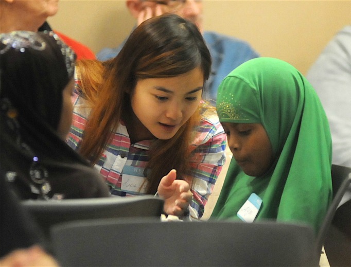Lisa Tu, a senior at the College of St. Benedict in St. Joseph, talks with 9-year-old Ayan Musse at a Sept. 22 Christian-Muslim dialogue meeting at St. Joseph’s Church in St. Joseph, Minnesota. Lisa Tu, a senior at the College of St. Benedict in St. Joseph, talks with 9-year-old Ayan Musse at a Sept. 22 Christian-Muslim dialogue meeting at St. Joseph’s Church in St. Joseph, Minnesota.