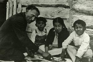 Above, Nicholas Black Elk uses the Two Roads catechism to teach some children about the Catholic faith. Below, Black Elk, holding the rosary, with his daughter Lucy Looks Twice.
Above, Nicholas Black Elk uses the Two Roads catechism to teach some children about the Catholic faith. Below, Black Elk, holding the rosary, with his daughter Lucy Looks Twice.