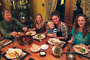 John Cuddeback with wife Sofia and three of their children — Josefina, 14, Juliana 12, and Raphael, 5 — gathered at the table. John Cuddeback with wife Sofia and three of their children — Josefina, 14, Juliana 12, and Raphael, 5 — gathered at the table.