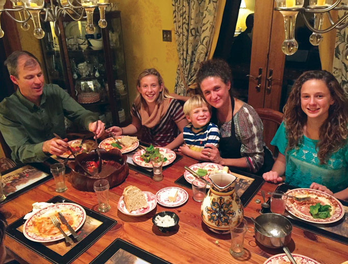 John Cuddeback with wife Sofia and three of their children — Josefina, 14, Juliana 12, and Raphael, 5 — gathered at the table. John Cuddeback with wife Sofia and three of their children — Josefina, 14, Juliana 12, and Raphael, 5 — gathered at the table.