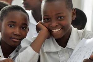 USAID report image shows children at school.