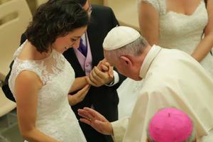Pope Francis blesses a recently married couple and their unborn child during the Aug. 5 general audience in the Vatican's Paul VI Audience Hall. Pope Francis blesses a recently married couple and their unborn child during the Aug. 5 general audience in the Vatican's Paul VI Audience Hall.