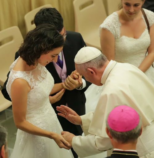 Pope Francis blesses a recently married couple and their unborn child during the Aug. 5 general audience in the Vatican's Paul VI Audience Hall. Pope Francis blesses a recently married couple and their unborn child during the Aug. 5 general audience in the Vatican's Paul VI Audience Hall.