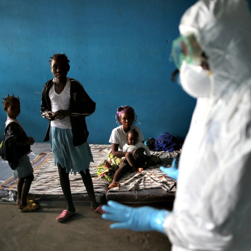 A Liberian health worker speaks with families in a classroom now used as Ebola isolation ward in Monrovia, Liberia. A Liberian health worker speaks with families in a classroom now used as Ebola isolation ward in Monrovia, Liberia.